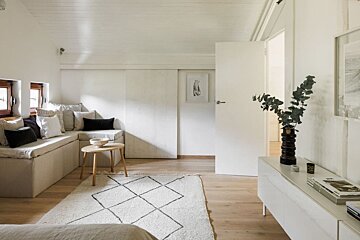 A living room with a couch and a rug