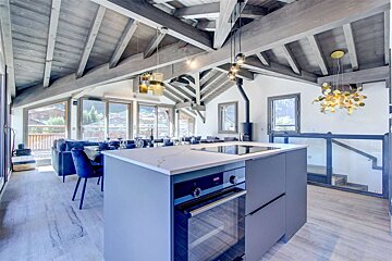 A kitchen with a large island and a stove top oven