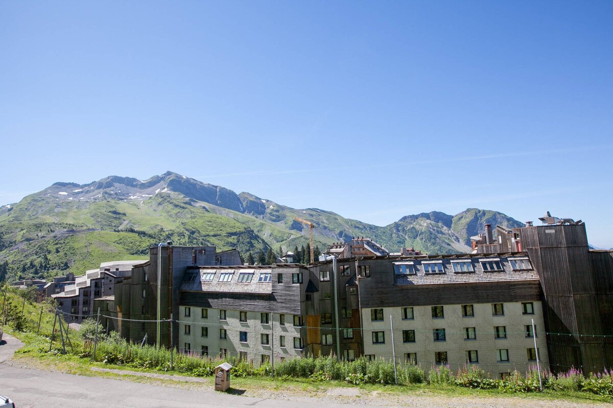 A large building with a mountain in the background