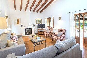 A living room with a fireplace and a flat screen tv