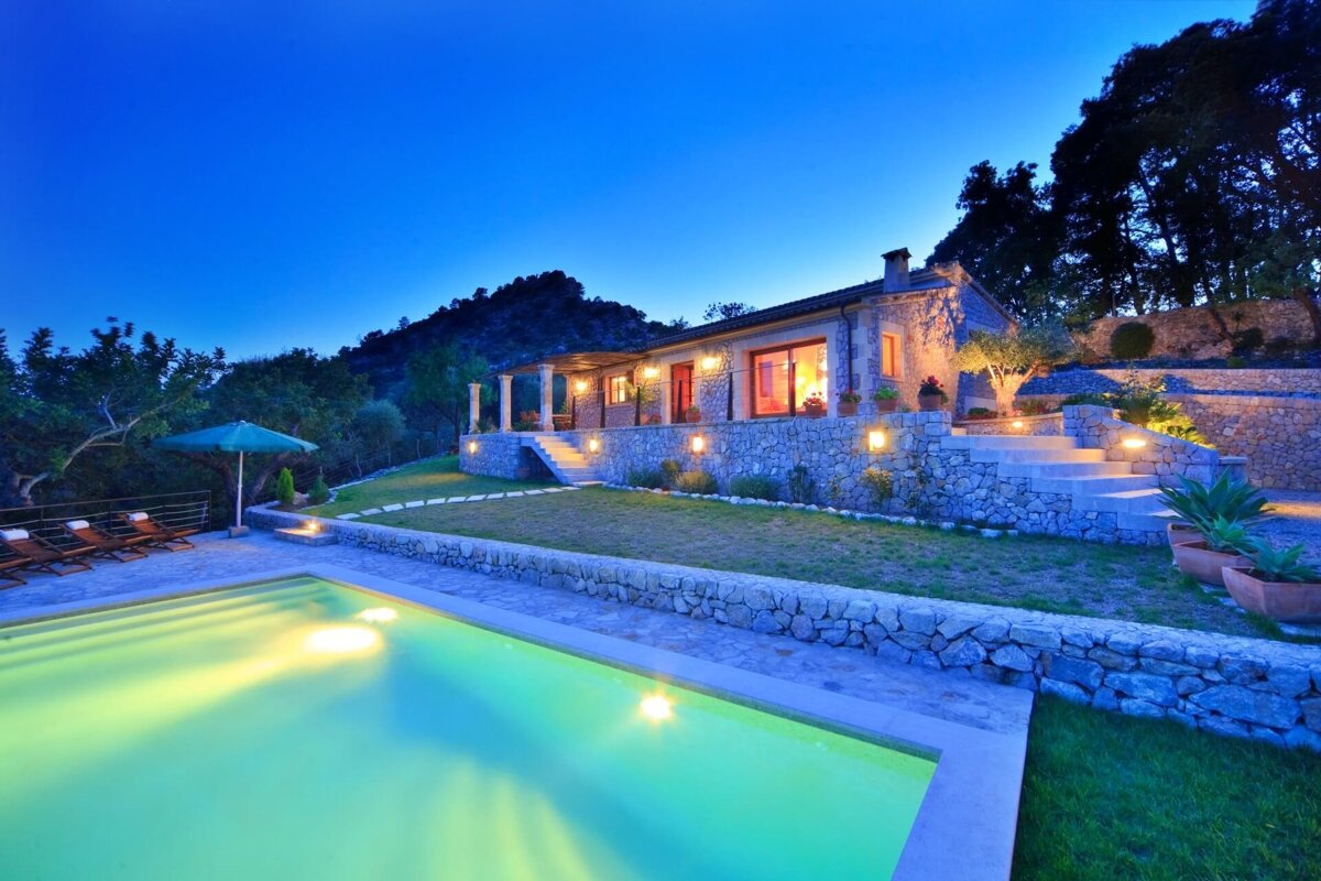 A house with a swimming pool in front of it