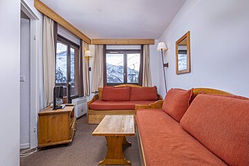 A living room with a couch and a television