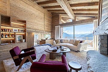 A living room with a couch and two chairs