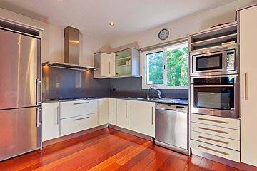 A kitchen with stainless steel appliances and white cabinets