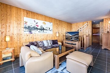 A living room with a couch and a flat screen tv