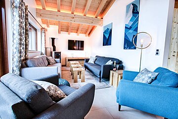 A living room with a couch and two chairs