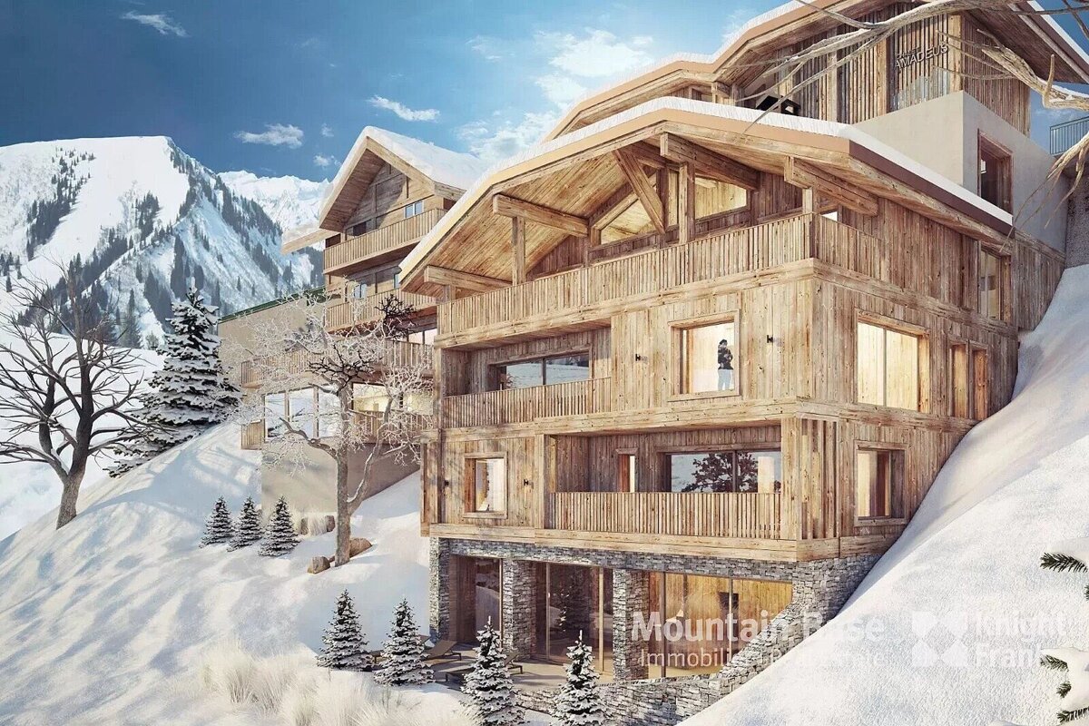 A luxurious multi-story wooden chalet nestled in a snowy mountain landscape with evergreen trees under a bright blue sky.