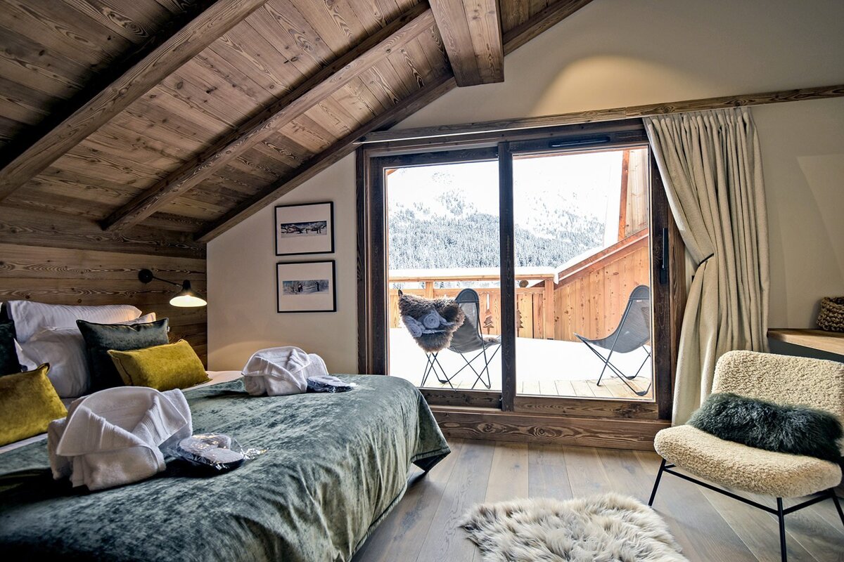 A bedroom with a sliding glass door leading to a balcony