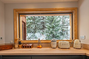 Two smeg toasters sit on a kitchen counter