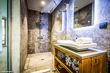 A bathroom with a sink and a walk in shower