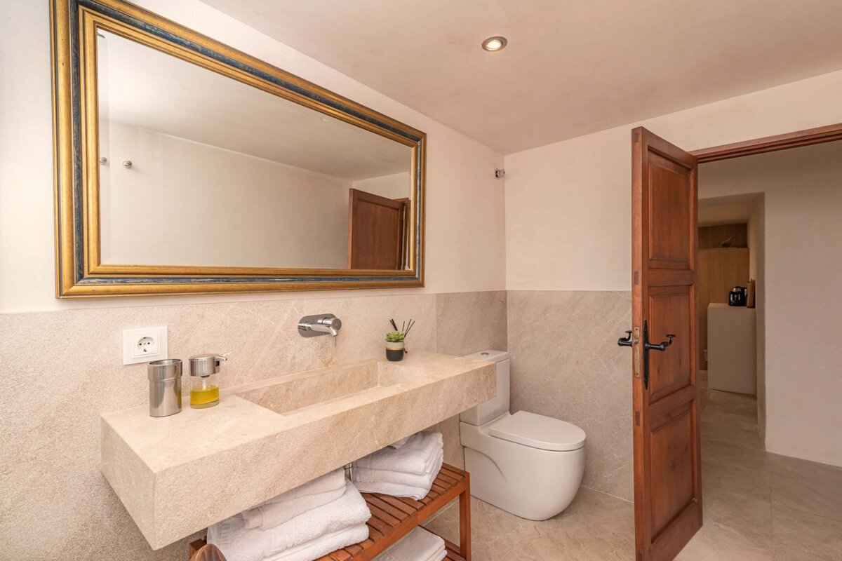 A bathroom with a large mirror and a sink