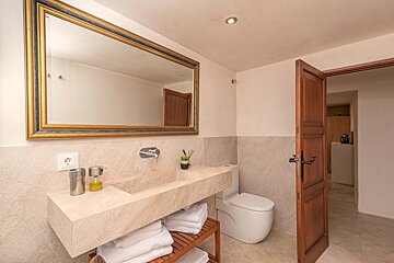 A bathroom with a large mirror and a sink