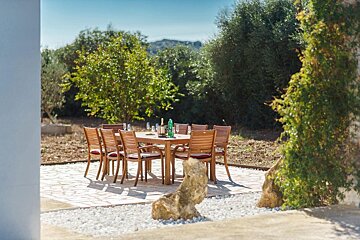 A ping pong table under a canopy with mountains in the background