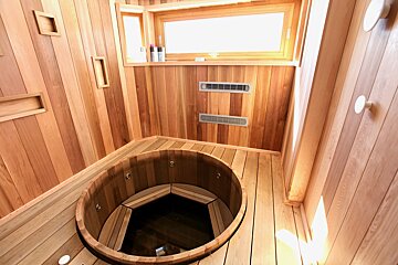 A bathroom with a wooden tub and a window