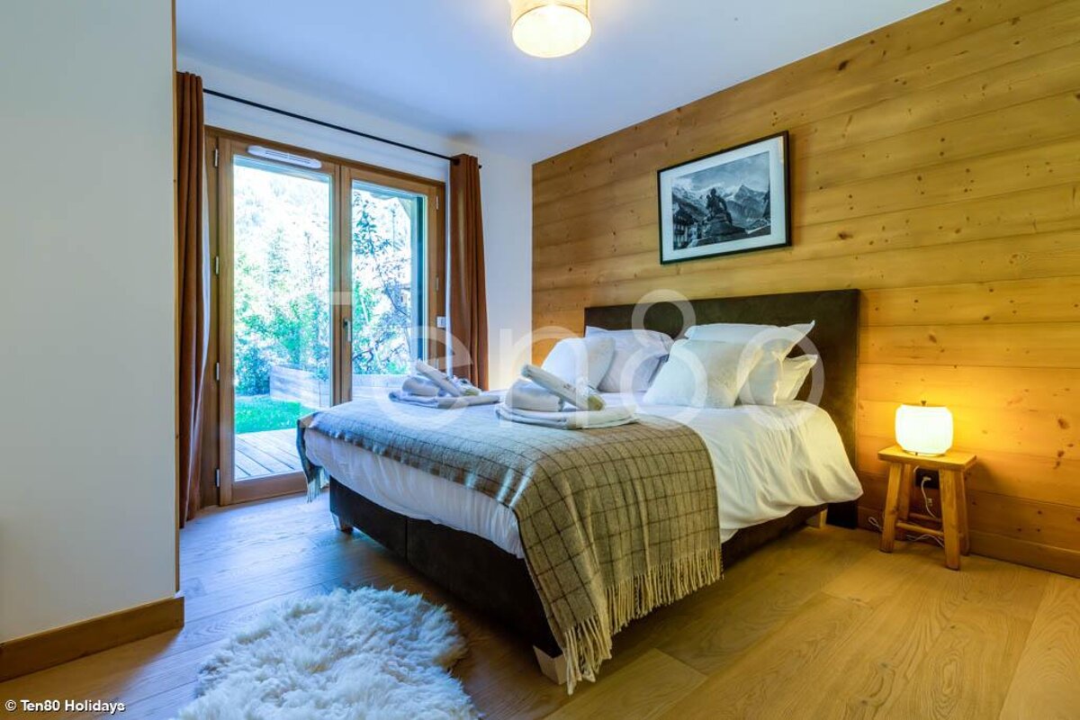 A bedroom with a bed and a picture on the wall