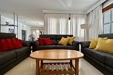 A bedroom with a large bed and a couch