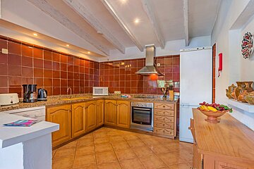 A kitchen with wooden cabinets and a white refrigerator