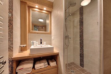 A bathroom with a sink and a walk in shower