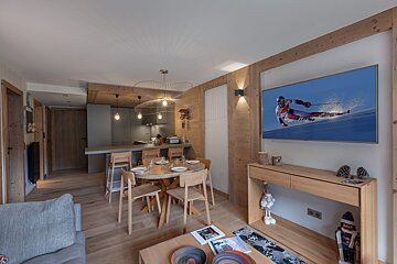 A living room with a flat screen tv showing a skier