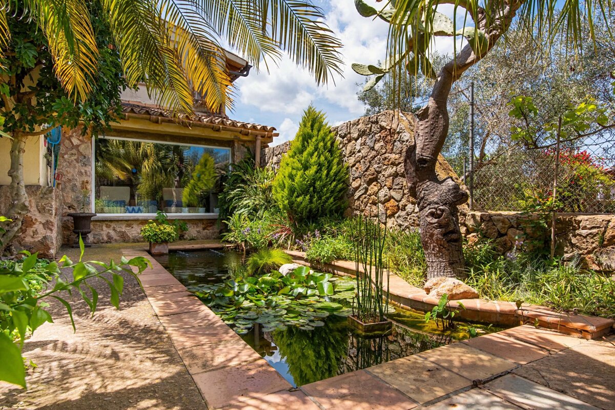 A house with a pond in front of it