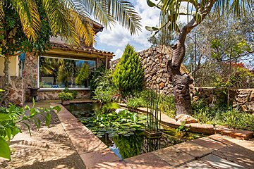A house with a pond in front of it