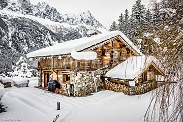 A photo of a snowy cabin taken by holidays
