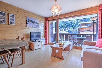 A living room with a couch a table and a flat screen tv