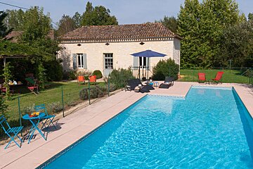 A large swimming pool in front of a house