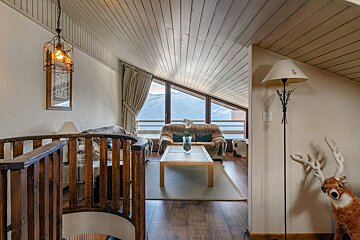 A living room with a couch a table and a lamp