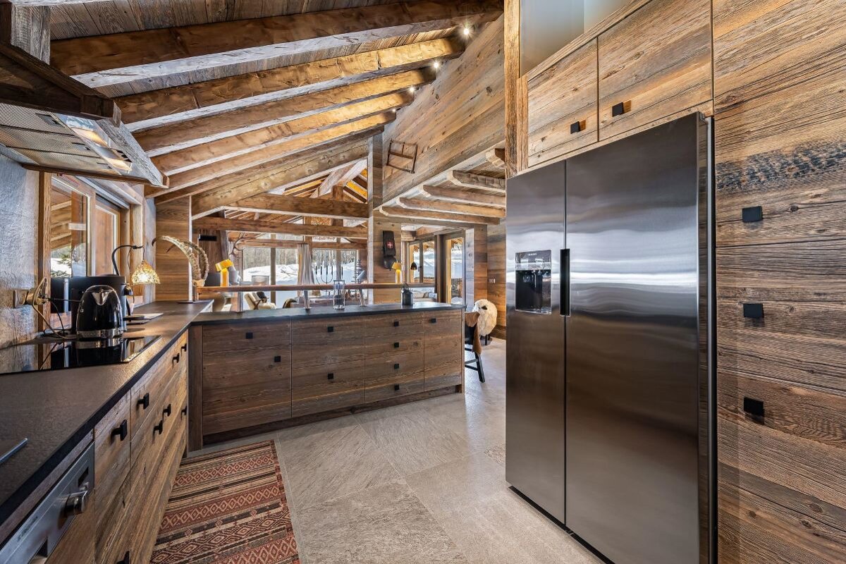 A kitchen with stainless steel appliances and wooden cabinets