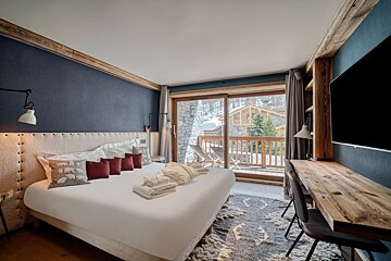 A hallway with a painting of snowy trees on the wall