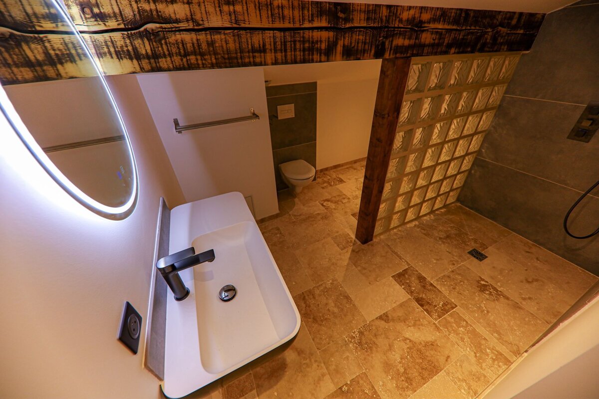 A bathroom with a sink a mirror and a toilet