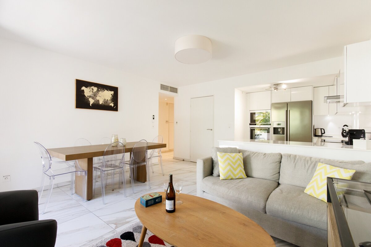 A bottle of wine sits on a coffee table in a living room