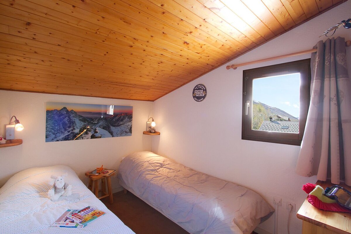 A bedroom with a single bed and a sign on the wall that says 