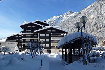 A row of buildings with mountains in the background