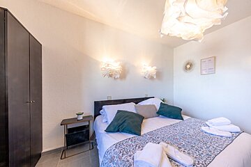 A bedroom with a bed and a sign on the wall that says