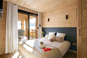 A bedroom with a bed and a book on it