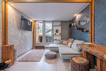 A living room with a couch and a flat screen tv