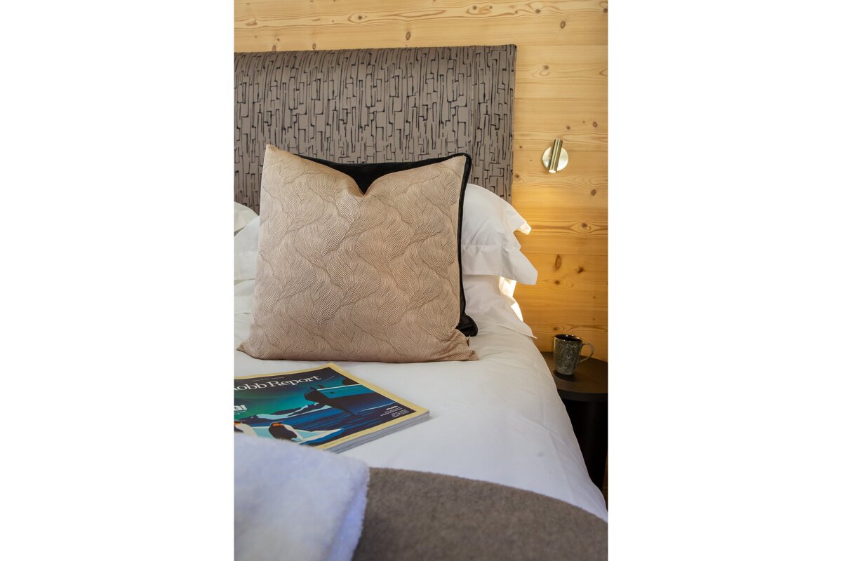 A bed with a pillow and a book on it that says odds report