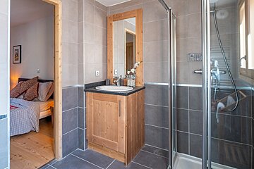 A bathroom with a sink and a walk in shower