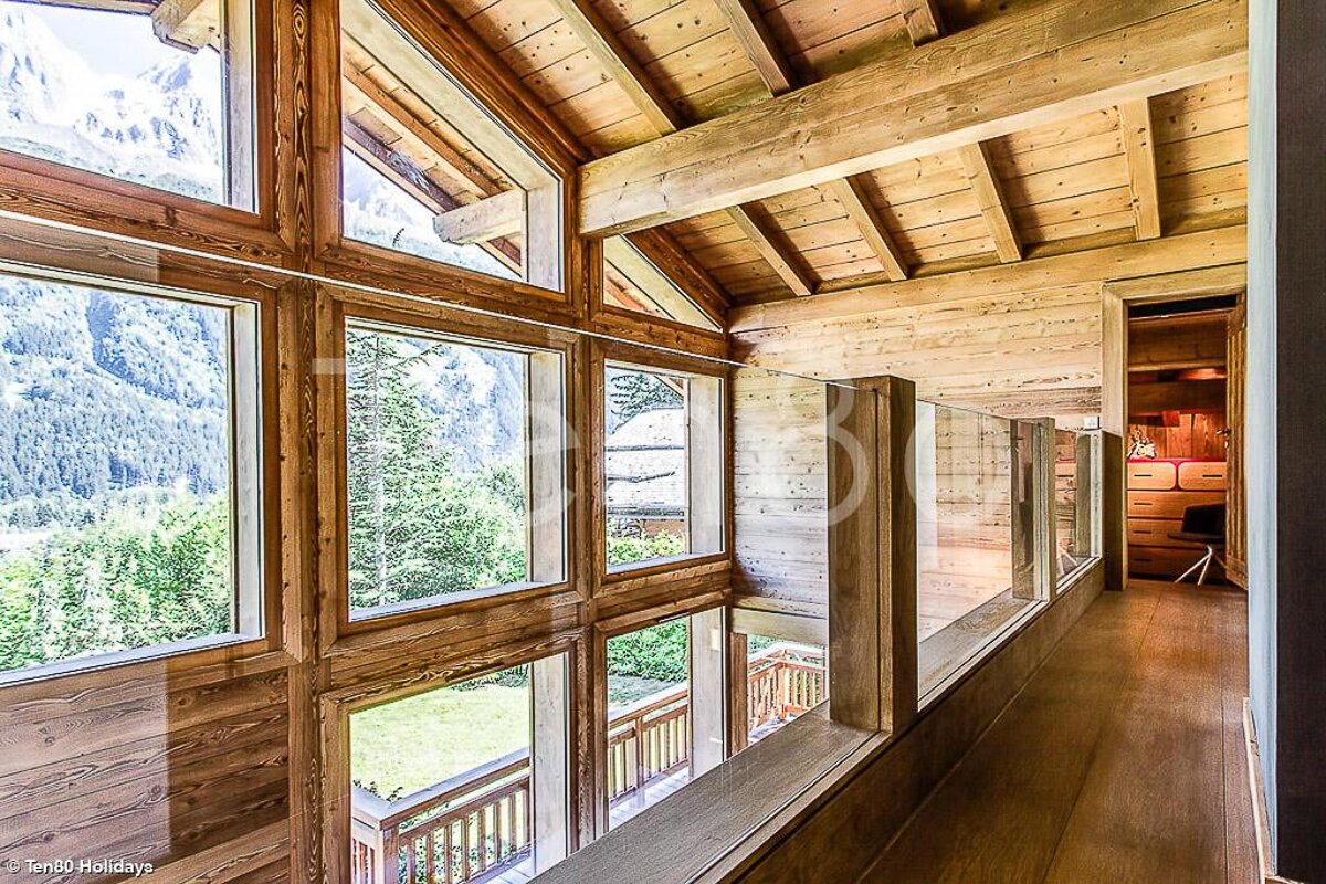 A wooden hallway with lots of windows and the word holidays at the bottom