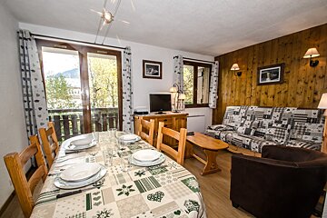 A living room with a table and chairs and a couch