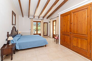 A bedroom with two beds and wooden doors