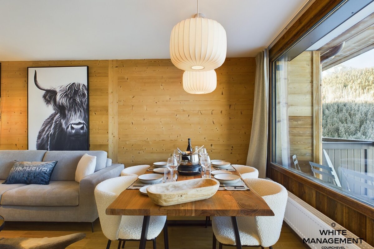 A bedroom with a bed and pictures on the wall