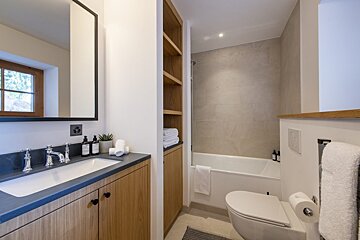 A bathroom with a sink toilet and bathtub