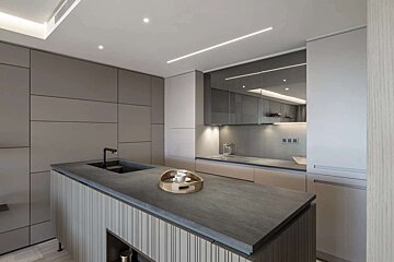 A kitchen with a wooden tray on the counter