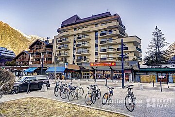 Bikes are parked in front of a building that says restaurant