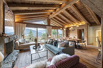 A living room with a couch a table and a fireplace