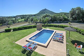 A large swimming pool with a mountain in the background