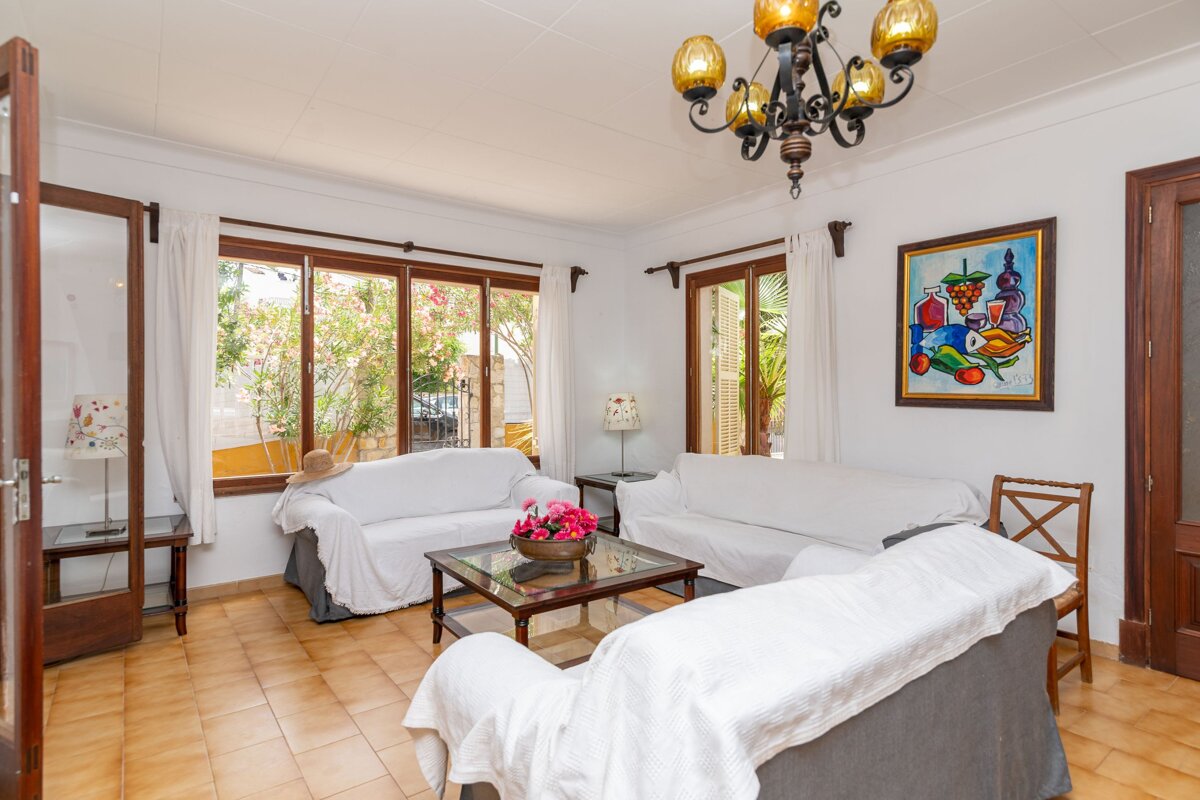 A living room with two couches and a painting on the wall